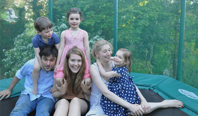 Karine's children and their au pair on a trampoline