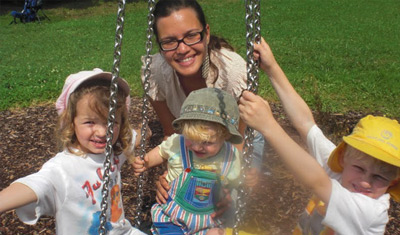 Marina and her host kids on a playground