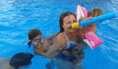 Marta con sus hijos invitados en la piscina.