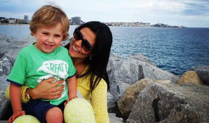 Ana on the beach with sunglasses with her host child