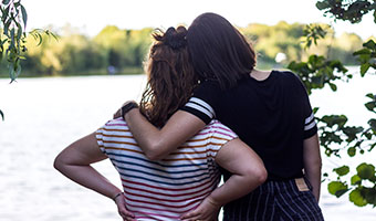 Two au pairing friends look at a lake