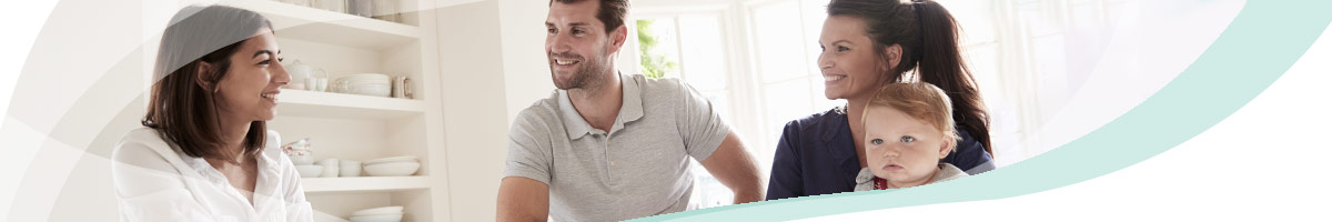 A couple with a young child receiving advice in an office