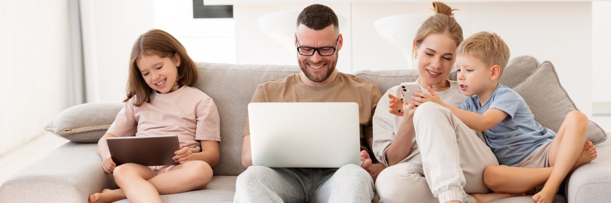 Family on the sofa with laptops