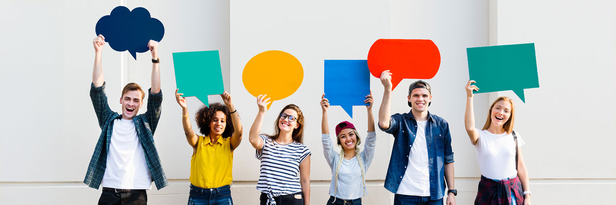 Young people hold speech bubbles in the air