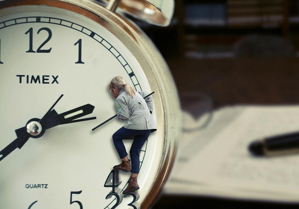 A child climbs on the face of a clock