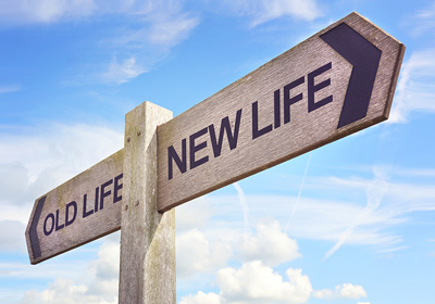 A signpost with two directions - old life and new life