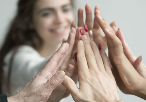Several people doing a high five