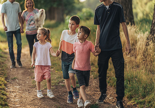 Children on a walk holding hands
