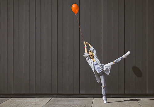 Woman holding a red ballon