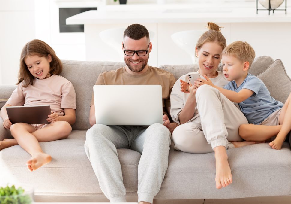 Family on the sofa with laptops