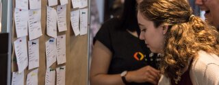 An au pair places her profile card at the attendant's board