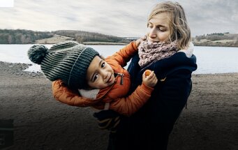 Au pair with child on the beach
